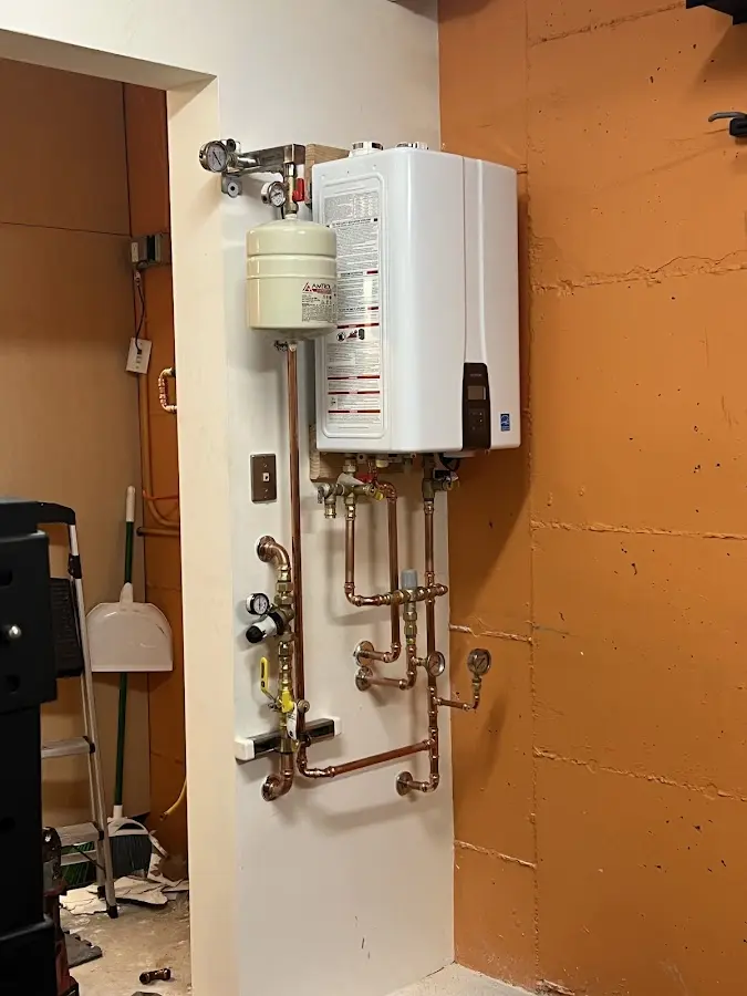 Plumbing technician inspecting water heater connections in Lakeland